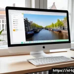 웹 기술을 통한 장애인 접근성 강화 방법 - A modern web developer’s workspace in Amsterdam, featuring a large monitor displaying a clear, consi...
